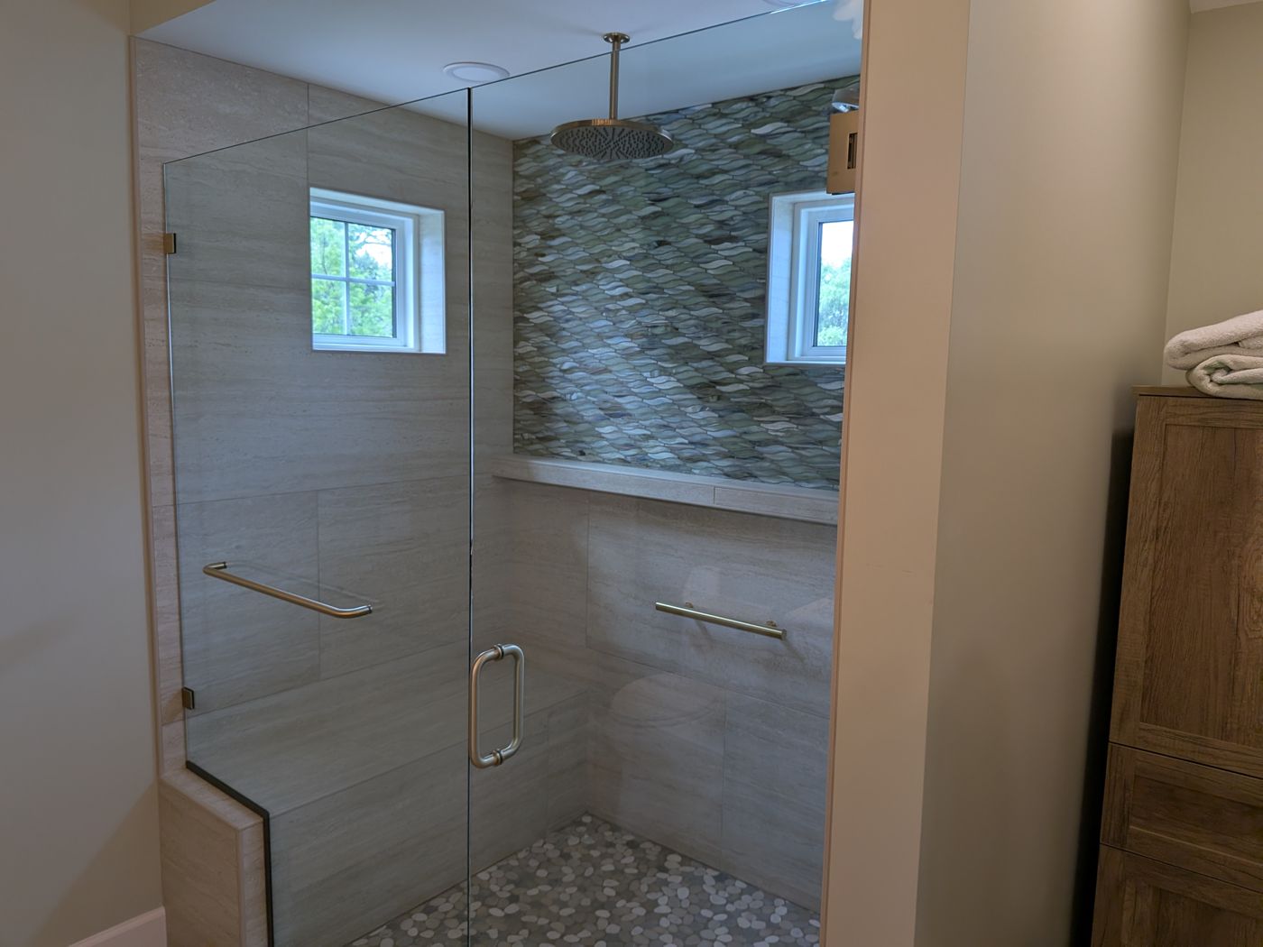 Frameless glass shower enclosure with brushed gold hardware installed by Borer Mirror & Glass